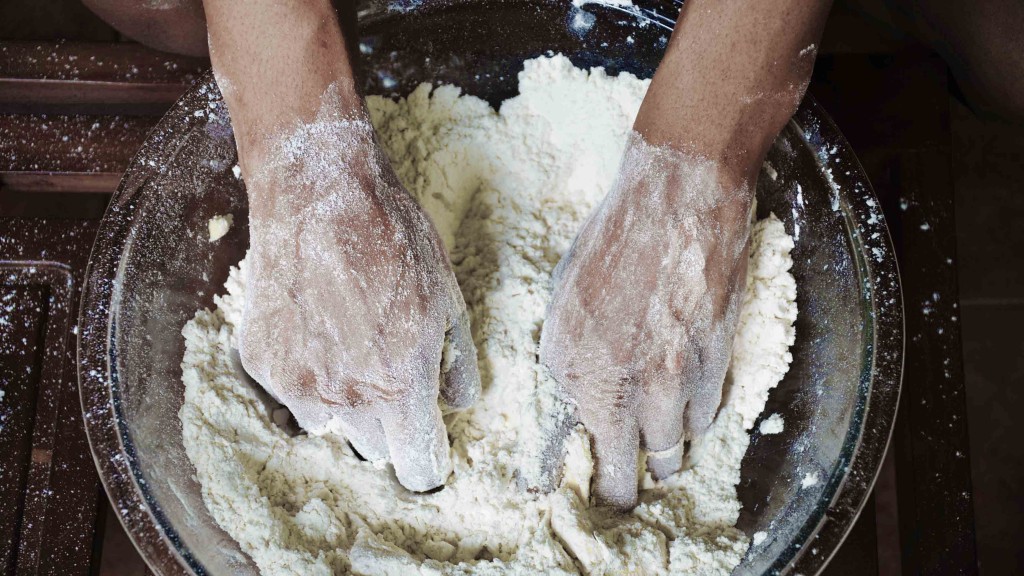 Hands mixing dough
