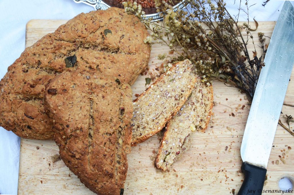 two-loaves-and-two-slices-of-multigrain-bread-on-a-table