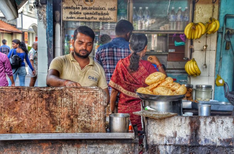 Man frying poori in india